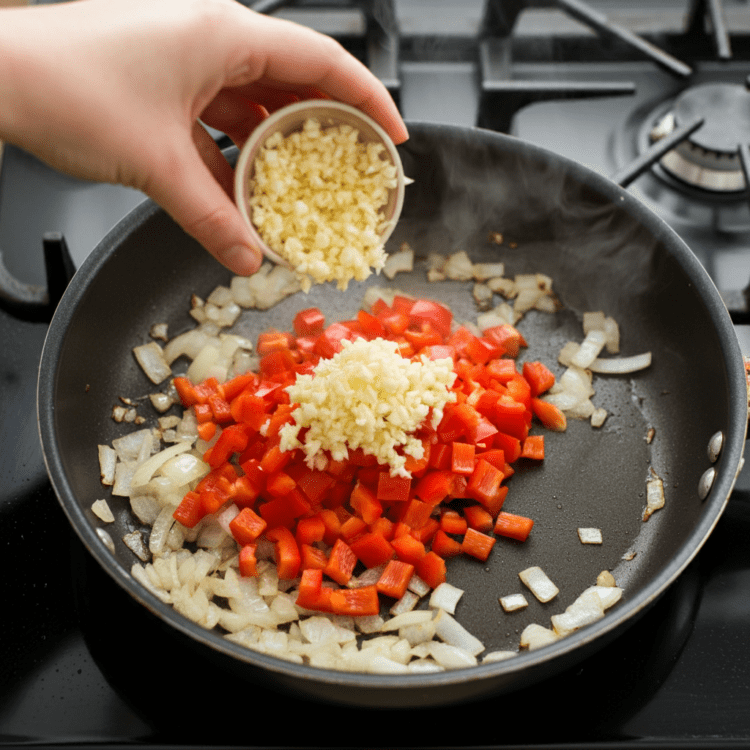 Sautéing onions and garlic in a pan for easy chili con carne, adding flavor to the base of the dish