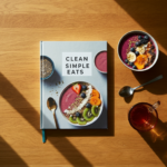 Healthy, colorful meal with fresh vegetables, lean protein, and quinoa, showcasing the concept of clean simple eating in a rustic kitchen setting